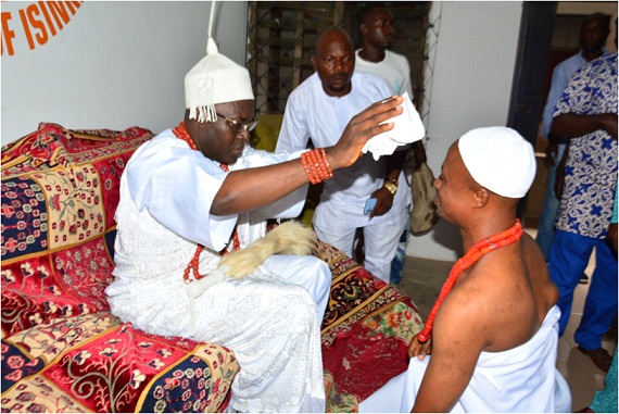 The new Olu of Aladodo, Chief Ayodeji Charles Fatoki (R), receiving royal blessings from Iralepo of Isinkan, Oba Olugbenga Ojo at the ceremony