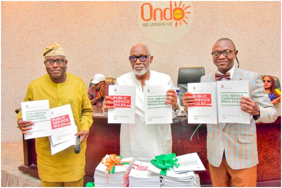 From left: Outgone Ondo State Head of Service, Pastor John Adeyemo, Governor Arakunrin Oluwarotimi Akeredolu and the new Head of Service, Pastor Kayode Ogundele, unveiling new Public Service Rules and Civil Service Commission Regulations, during the swearing-in- of the new HoS,  held in Akure