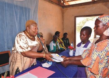 From left: Senior Special Assistant (SSA) to Ondo State Governor on Women Affairs, Mrs Kehinde Omolara Adeniran, presenting cash  and educational materials to a beneficiary, Rokibat Sodiq, while her mother supports, during the empowerment programme in Idoani                                                                                                                      Photo: Ayodele Suberu