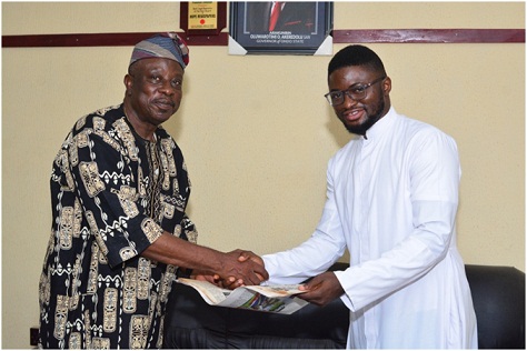 From left: Chairman/Editor-in-Chief of Owena Press Limited, Sir Ademola Adetula, presents a copy of The Hope to Director, Social Communications Catholic Diocese of Ondo, Rev. Fr. Augustine Ikwu, during the visit
 Photo: Stephen Olajide