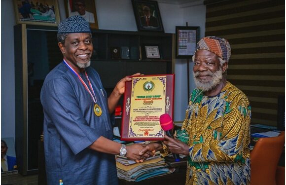 From left: Ondo State Commissioner for Finance, Mr Wale Akinterinwa, receiving the award from  renowned Actor, Dr. Chief Peter Fatomilola