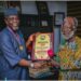 From left: Ondo State Commissioner for Finance, Mr Wale Akinterinwa, receiving the award from  renowned Actor, Dr. Chief Peter Fatomilola