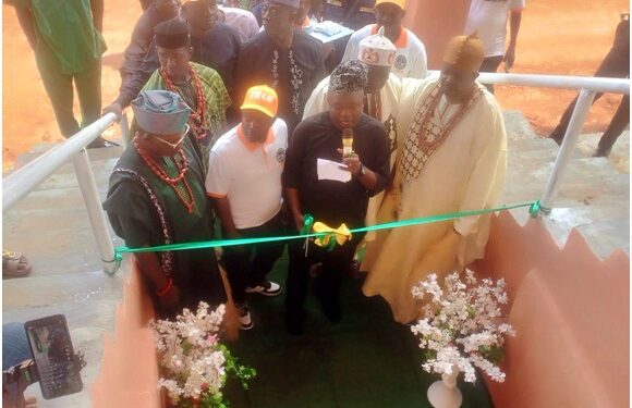 Commissioner for Local Government and Chieftaincy Affairs, Mr Amidu Takuro, cutting the tape to commission the stadium