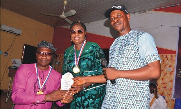 From left: Head of Circulation, Owena Press Limited, Mr Ayokunle Awe, receiving an Award as Patron of NYCN on behalf of Chairman/Editor-in-Chief of the Company, Sir Ademola Adetula, from Mrs Femi Ayodele Rachael who represented Secretary to the State Government, Princess Oladunni Odu and Chairman of the Council, Mr Mathew Ogunmolawa at the event                                              Photo: Ayodele Suberu