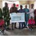 GM ODCSDA, Bosun Ogundipe presenting a cheque to a community
