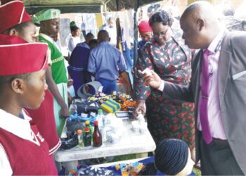 Permanent Secretary, Ondo State Ministry of Education, Science and Technology, Folasade Adegoke, assessing crafts displayed by students at the Global Entrepreneurship Exhibition held in Akure on Tuesday